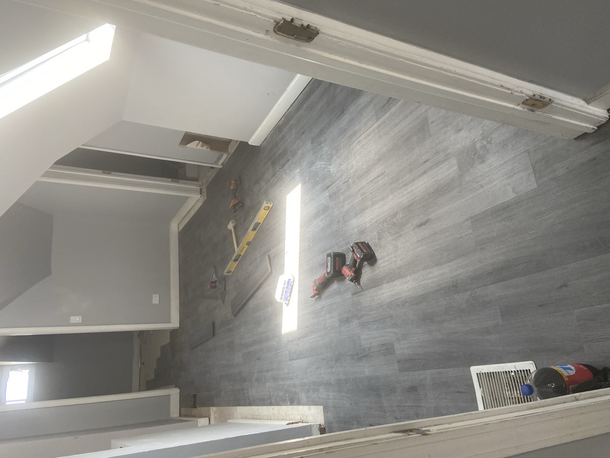 Room after renovation - new flooring, painted walls, modern finishes